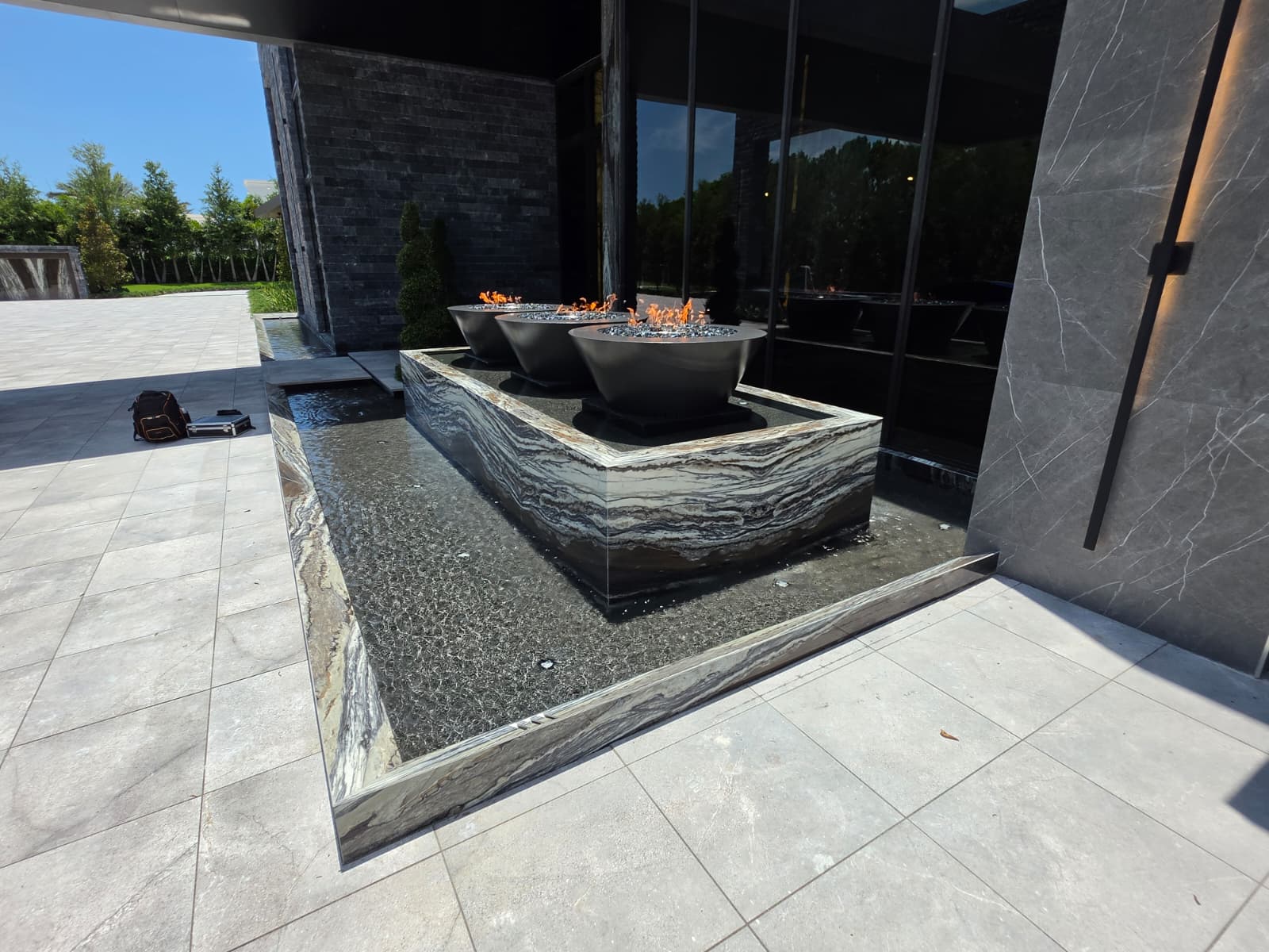 Modern stone fountain with fire bowls