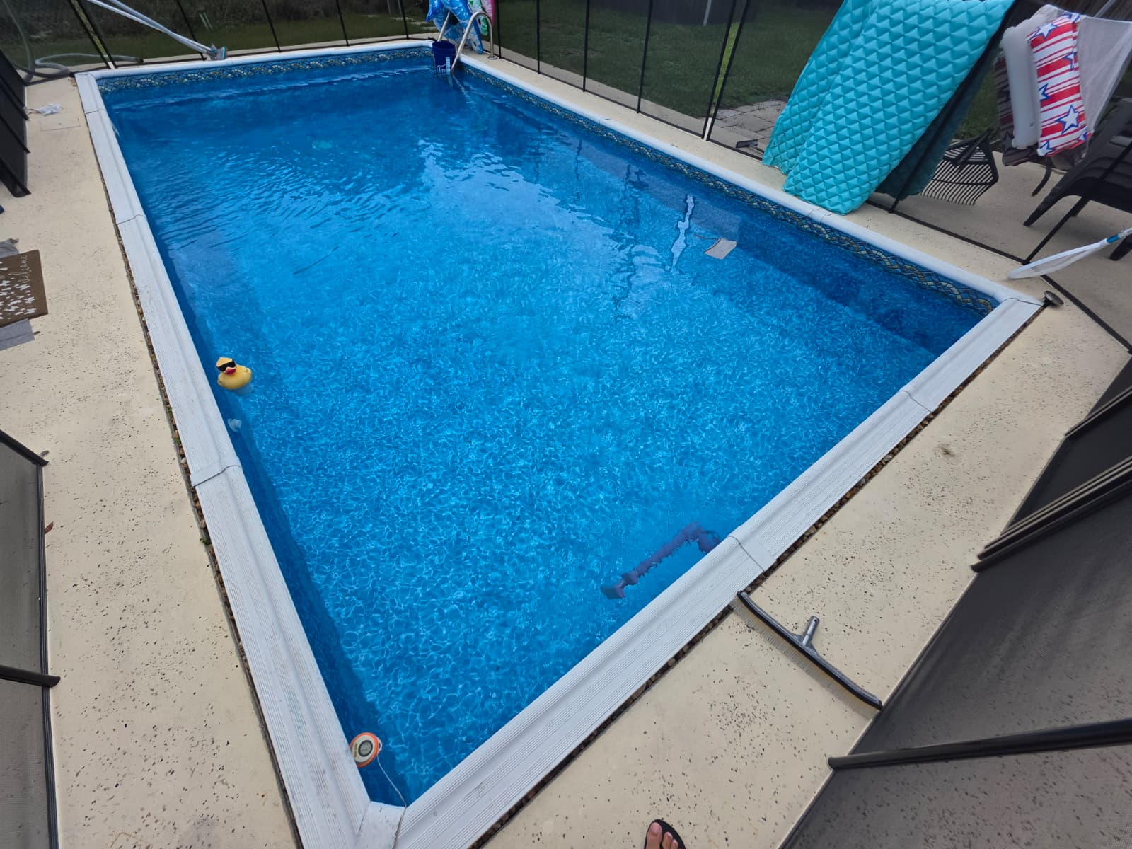 Residential swimming pool with a blue vinyl liner